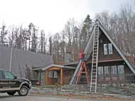 Holiday lights being put on the front of the inn.