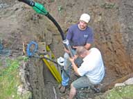Plumbers getting ready to drop a new pump 600 feet down the inn's well.