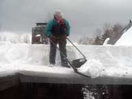 Clearing snow from a roof at the inn.