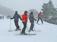 Gary, Chuckles, Ruts and the Bagel on Killington Peak in the snow.