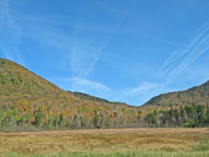 Jet contrails lace the sky above Beaver Pond on Route 4 in Mendon VT