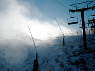 Snow guns covering Superstar with snow in the morning sun.