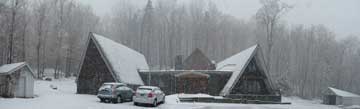 Birch Ridge Inn being blanketed in white by spring snow storm.