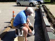 Mixing a bucket of concrete to repair the front garden wall at the Birch Ridge Inn