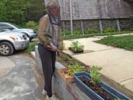 Mary in full regalia planting the garden in front of the Birch Ridge Inn