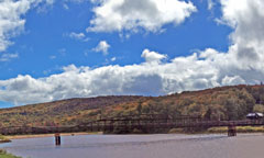 Fall colors lighting up the hillsides behind the Snowshed Pond.