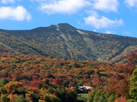 caption=Killington Peak draped in a mantle of fall colors.