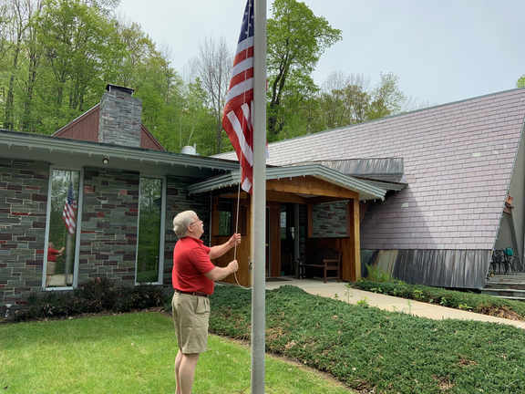 Bill raising the flag at the inn to start summer